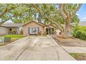 A charming single-story house with brick accents, a cozy front porch and a concrete driveway at 4613 Summerwind Ct, Plant City, FL 33566