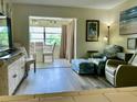 Cozy living room featuring wood-look floors and relaxing seating area at 4712 Marine Pkwy # 203, New Port Richey, FL 34652