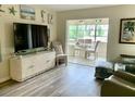 Bright living room with view to dining area and beach-themed decor at 4712 Marine Pkwy # 203, New Port Richey, FL 34652