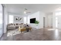 Stylishly decorated living room with comfortable seating, a modern area rug, and a large flat-screen television at 5017 46Th W St, Bradenton, FL 34210