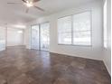 Open-concept living space with tile flooring, ceiling fan, and sliding glass doors at 5017 46Th W St, Bradenton, FL 34210