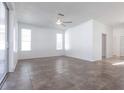 Bright living room with neutral tile floors, a ceiling fan and sliding doors to the outside at 5017 46Th W St, Bradenton, FL 34210