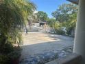 Wide driveway with a white metal gate and lots of space for parking at 5106 Gateway Dr, Tampa, FL 33615