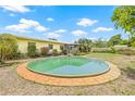 Lush backyard featuring a unique above-ground pool, perfect for relaxation and entertainment at 5821 52Nd N Ave, Kenneth City, FL 33709