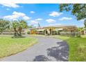 Expansive front yard featuring a circular driveway leading up to the home's entrance at 5821 52Nd N Ave, Kenneth City, FL 33709