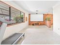 Bright living room features a large window, movie screen, and wood accent wall at 5821 52Nd N Ave, Kenneth City, FL 33709