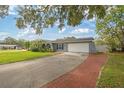 A lovely one-story house featuring an attached garage and a brick-laid driveway at 602 Hillpoint Way, Brandon, FL 33510