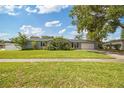 Well-maintained one-story home featuring a lush green lawn and mature trees at 602 Hillpoint Way, Brandon, FL 33510