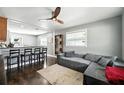 Inviting living space with a gray couch, dark wood floors, and modern ceiling fan at 6212 S Adelia Ave, Tampa, FL 33616