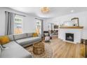 Bright living room featuring fireplace, hardwood floors, neutral colors, and an abundance of natural light at 650 63Rd S Ave, St Petersburg, FL 33705