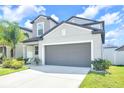 Attractive two-story home featuring a two-car garage, lush lawn and landscaped yard at 797 Olive Conch St, Ruskin, FL 33570