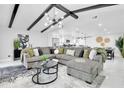 Spacious living room with vaulted ceilings, beam accents, modern lighting and an open floorplan at 8010 W Hiawatha St, Tampa, FL 33615
