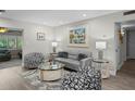 Comfortable living room with neutral tones, elegant decor, and ample seating, perfect for relaxation at 8718 Tahiti Ln, Tampa, FL 33615