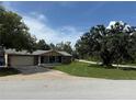 Charming single-story home with stone accents, attached garage, and a well-manicured front lawn in a serene setting at 9171 Vicksburg Rd, Spring Hill, FL 34608