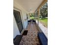 Comfortable porch with seating and beautiful outdoor views at 9171 Vicksburg Rd, Spring Hill, FL 34608