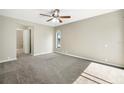 Bedroom with neutral carpet, a ceiling fan, and a window for natural light at 9807 Stephenson Dr, New Port Richey, FL 34655