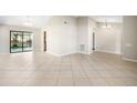 Spacious living room with tile floors and natural light from the sliding glass doors to the patio at 9807 Stephenson Dr, New Port Richey, FL 34655