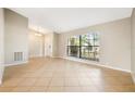 Bright living room featuring tiled floors, large windows, and neutral wall paint at 9807 Stephenson Dr, New Port Richey, FL 34655