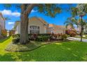 Beautiful landscaping frames this home, showcasing vibrant plants, trees and well-maintained lawn at 10361 Lightner Bridge Dr, Tampa, FL 33626