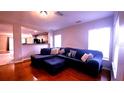 Bright living room with hardwood floors, large windows, and a comfortable sectional sofa at 10819 Lake Saint Charles Blvd, Riverview, FL 33578