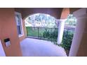 Covered porch area with decorative pillars and wrought iron railing, offering a shady outdoor space at 10819 Lake Saint Charles Blvd, Riverview, FL 33578
