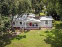 Aerial view of a charming single-story home with a welcoming front porch and a spacious, well-maintained lawn at 11704 Orange Grove Ter, Riverview, FL 33569