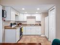 Bright kitchen with white cabinets, tile floors and modern appliances ready for your culinary expertise at 11704 Orange Grove Ter, Riverview, FL 33569