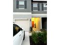 Charming front exterior view featuring a garage and front door accentuated by green landscaping at 11847 Dumaine Valley Rd, Riverview, FL 33579