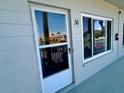 Condo unit entrance with the unit number and a view of the tropical landscaping outside at 2070 World Parkway Blvd # 36, Clearwater, FL 33763