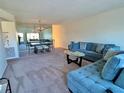 Spacious living room featuring a plush sofa, a large mirror, and an elegant dining set at 2070 World Parkway Blvd # 36, Clearwater, FL 33763