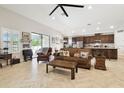 Open-concept living room with tile flooring, adjacent to the modern kitchen at 21837 Briske Morning Ave, Land O Lakes, FL 34637
