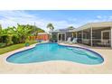 Beautiful kidney-shaped pool with lounge chairs, patio and a lush garden create a private backyard retreat at 2581 61St S Ave, St Petersburg, FL 33712