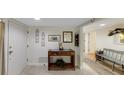 A lovely home foyer with neutral tones, tiled floors, and a decorative wooden console table at 3035 Countryside Blvd # 16B, Clearwater, FL 33761