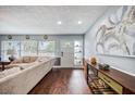 Bright living room with hardwood floors, modern decor, and a view of the front door at 3173 Fountainhead Dr, Largo, FL 33770