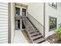 Exterior view showcasing the stairway leading to the upper-level entrances, highlighting the inviting design at 326 Moorings Cove Dr # 2B, Tarpon Springs, FL 34689