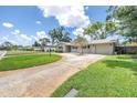 Inviting home exterior with a circular driveway, green lawn, and blue accents on the windows at 3652 18Th N Ave, St Petersburg, FL 33713