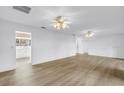 Bright, open living space with light wood flooring and multiple ceiling fans at 3652 18Th N Ave, St Petersburg, FL 33713