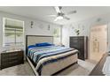 Serene main bedroom with a ceiling fan, neutral colors, and an abundance of natural light at 39024 Harlow Rose Dr, Zephyrhills, FL 33540