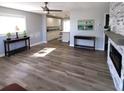 Bright living room featuring luxury vinyl plank flooring, modern fireplace, and updated fixtures at 4470 Mainlands W Blvd, Pinellas Park, FL 33782