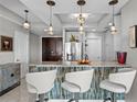 Stylish kitchen bar with white seating and decorative tile, illuminated by pendant lighting at 449 S 12Th St # 1004, Tampa, FL 33602