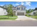 Inviting two-story home with a manicured lawn, complemented by a spacious driveway at 4918 Wild Senna Blvd, Tampa, FL 33619