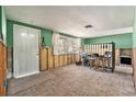 Partially renovated living room featuring tile flooring, a door, and a large window providing lots of natural light at 4928 Petunia Ct, New Port Richey, FL 34652