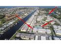 Aerial view of the property located on a waterway, showcasing the building, pool, and surrounding neighborhood near the beach at 5111 Amulet Dr # 208, New Port Richey, FL 34652