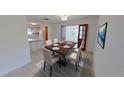 Dining room featuring an elegant table setting, tiled flooring, and double doors to another living space at 5337 11Th N Ave, St Petersburg, FL 33710