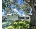 Well-maintained single-story home featuring a manicured lawn, an attached garage, and lush landscaping at 5337 11Th N Ave, St Petersburg, FL 33710