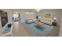 Open-concept living room featuring stylish furniture, a vibrant rug, and plenty of natural light at 5337 11Th N Ave, St Petersburg, FL 33710