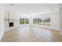 Spacious living room featuring a charming brick fireplace and abundant natural light at 6400 Mockingbird S Way, St Petersburg, FL 33707