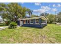 Charming single-story home with a well-manicured lawn and attached garage at 6401 N Central Ave, Tampa, FL 33604
