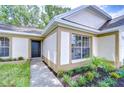Front Entrance showcasing the front door, landscaping, and walkway to the home at 6720 Gilda Dr, Tampa, FL 33625