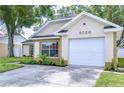 Charming single-Gathering home featuring an attached garage and well-maintained landscaping at 6720 Gilda Dr, Tampa, FL 33625